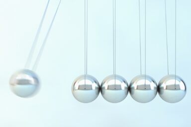 Newton's cradle with one silver sphere in motion, representing the assessment process for an ADHD diagnosis.