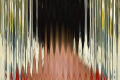 An abstract, distorted image of a person's face reflected in a warped mirror with vertical streaks of color.
