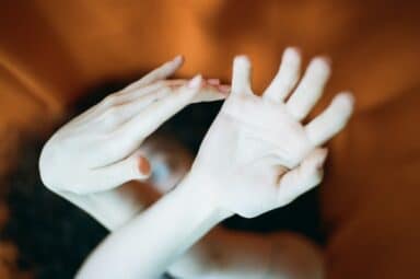 A woman's hands intertwined above her head, embodying the challenges of borderline personality disorder (BPD).
