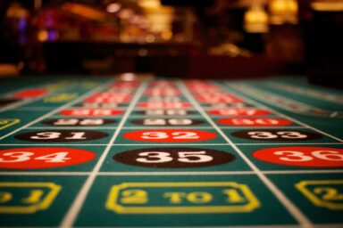 A roulette table at a casino, displaying colorful numbers, illustrating the problem of gambling addiction.
