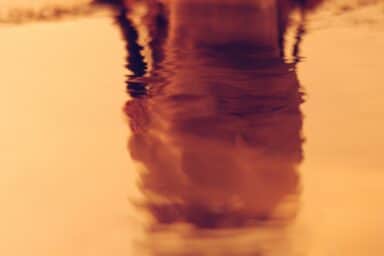 A face reflected in water