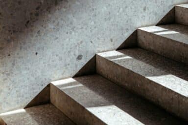 Sunlight and shadows fall across concrete stairs, symbolizing the path toward recovery and hope.