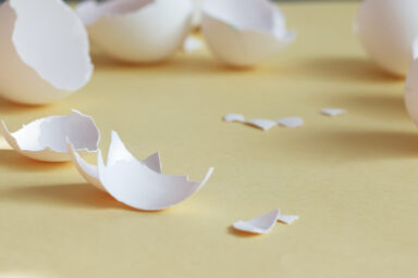 Broken eggshells scattered on the floor, illustrating the unhealthy dynamic of walking on eggshells in a relationship